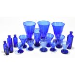 A group of blue glass comprising six chemist/pharmacy bottles with ribbed edges and inscribed 'Not