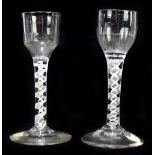 Two Georgian air twist wine glasses, the first with fluted ogee bowl, raised on opaque air twist