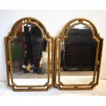 A pair of decorative gilt framed wall mirrors, 106 x 67cm.