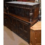 A late 17th century oak court cupboard with carved frieze above substantial ring turned uprights,