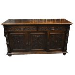 A large late Victorian carved oak sideboard, the moulded rectangular top above two drawers with '