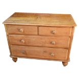 An old pine chest of two short and two long drawers on turned bun feet, width 105cm.