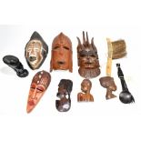 A group of African tribal ware including four masks, Malawi salad servers, bust, etc.Additional