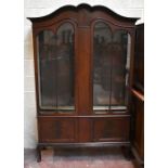 An Edwardian inlaid mahogany display cabinet with pair of glazed doors above two panel doors on