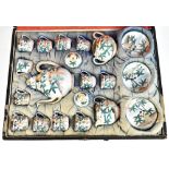 An early 20th century Japanese eggshell porcelain tea service decorated with figures and bamboo