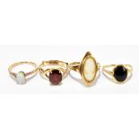 Two 9ct yellow gold dress rings set with cameo and oval cut red coloured stone respectively, the