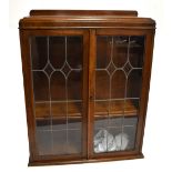 An early 20th century oak bookcase section from a bureau bookcase, with two leaded glazed doors