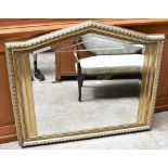 SELVA; a gilt framed bevelled wall mirror with arched top, 98 x 115cm.