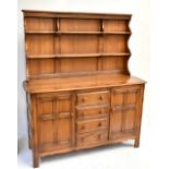 ERCOL; medium elm dresser with plate rack above four central drawers flanked by doors, width