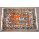 An Indian hand knotted park silk and woollen rug with central vase motif flanked by columns and