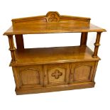 A Victorian Gothic oak buffet, the back rail carved with central trefoil above an undertier on