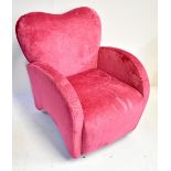 A stylish contemporary pink upholstered armchair with heart shaped back.