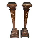 A pair of 19th century rosewood torchere stands, with bone inlay depicting exotic birds and