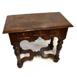 A good quality George III style reproduction oak side table with three drawers and turned column