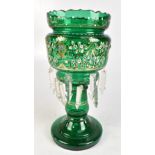 A 19th century green glass table lustre with gilt and enamelled floral decoration suspending clear