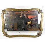 An Arts & Crafts sheet metal wall mirror of rectangular form with cast floral applied motifs, with