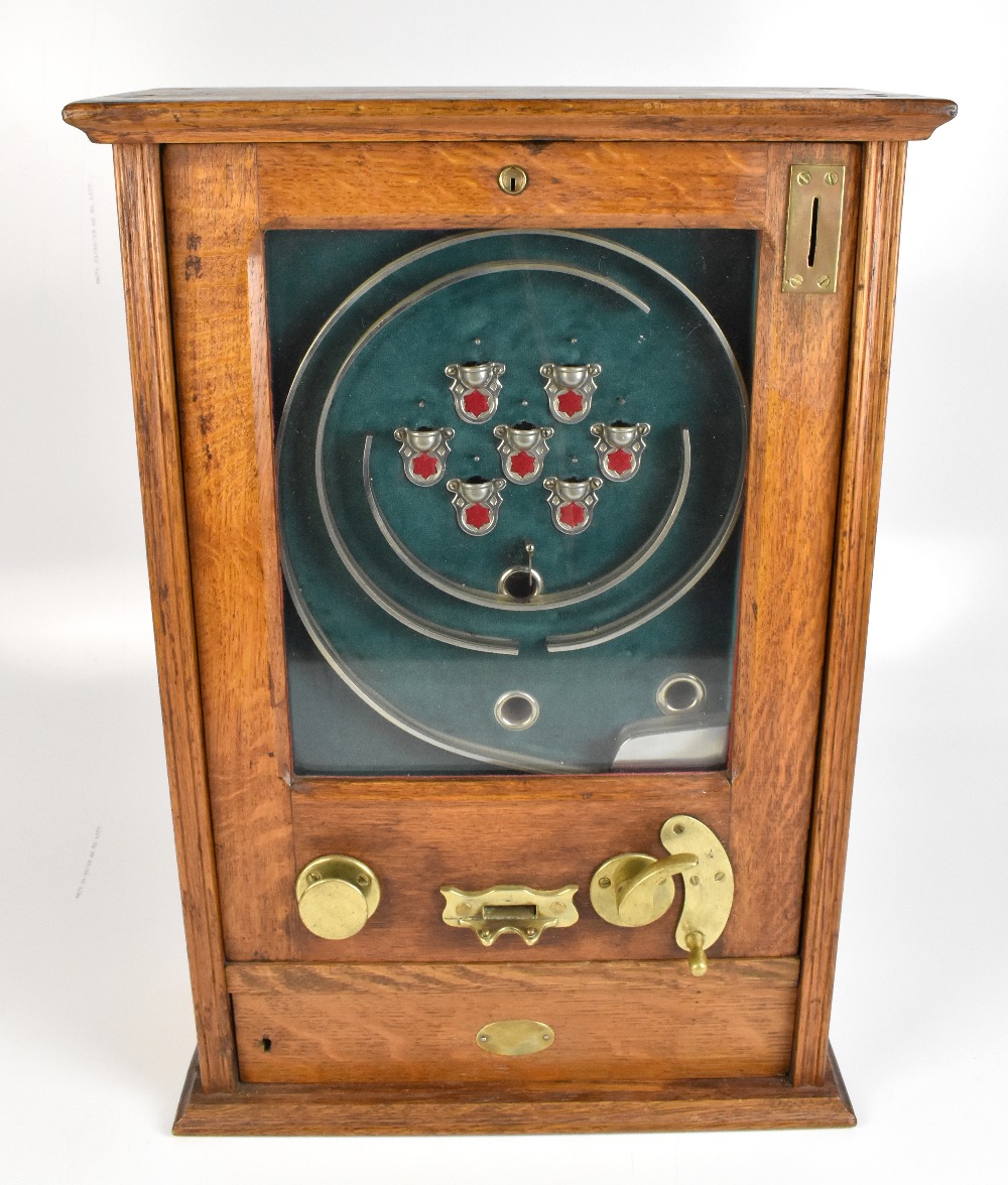 An early 20th century oak cased allwin machine, complete with two keys, height 65cm, width 45cm.