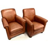 A pair of early 20th century armchairs, recently re-upholstered in brown leather on bun feet.