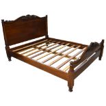 A reproduction hardwood kingsize bed, with carved detail, width 170cm.Additional InformationSold