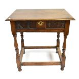 An oak side table with carved detail to frieze drawer on turned and stretchered supports, height