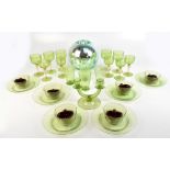 A group of green glass and gold flecked tableware including wine glasses, beakers, a set of six