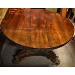 A Regency rosewood tilt top breakfast table, the circular top on three scrolling supports with paw