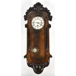 A Victorian walnut cased thirty hour wall clock with carved foliate and scroll detail, the