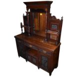 A late 19th century walnut sideboard with tripled bevelled mirror back above drawers and doors,