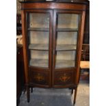 An Edwardian inlaid mahogany display cabinet with pair of bowfronted doors on square tapering