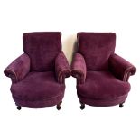 A pair of early 20th century lilac upholstered armchairs on cabriole legs.