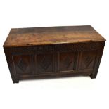 An antique oak coffer, the rectangular possibly later hinged top above a carved frieze 'Thomas