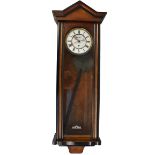 A 19th century Vienna style chain driven wall clock with circular dial and Roman numerals and