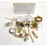 A quantity of assorted costume jewellery to include a cameo brooch, various fashion watches,