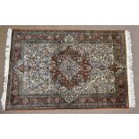 A fine Eastern hand knotted park silk and woollen rug, with elaborate foliate scrolling detail,