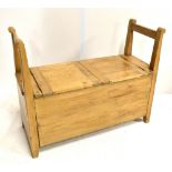 A European old pine storage seat with twin handles and twin hinged flaps, width 71cm height 78cm.