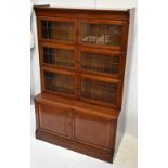 An early 20th century mahogany stacking bookcase, with three leaded glazed upper sections above a