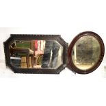 Two early 20th century bevelled wall mirrors, one rectangular shaped and one oval shaped.