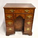 A George III style mahogany seven drawer kneehole desk on bracket feet, height 71.5cm, width 63.5cm,