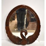 A modern mirror elaborated carved as a swan with outstretched wings, 100 x 80cm.