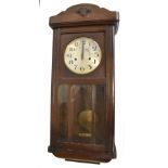 An early 20th century oak cased wall clock, the silvered dial set with Arabic numerals, height