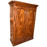 A Victorian mahogany wardrobe, with pair of panel doors on plinth base, width 140cm, height 210cm.