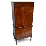A reproduction mahogany cocktail cabinet with two pairs of doors, width 66.5cm, height 151cm.