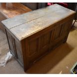 An oak coffer for restoration, the panelled front above two short drawers on stile supports, 77 x