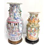 A 19th century Chinese Canton twin handled Famille Rose vase, painted in panels with stylised