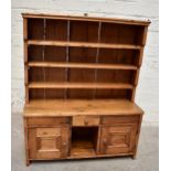 A miniature waxed pine dresser with plate rack above drawer and two cupboard doors, height 76cm,