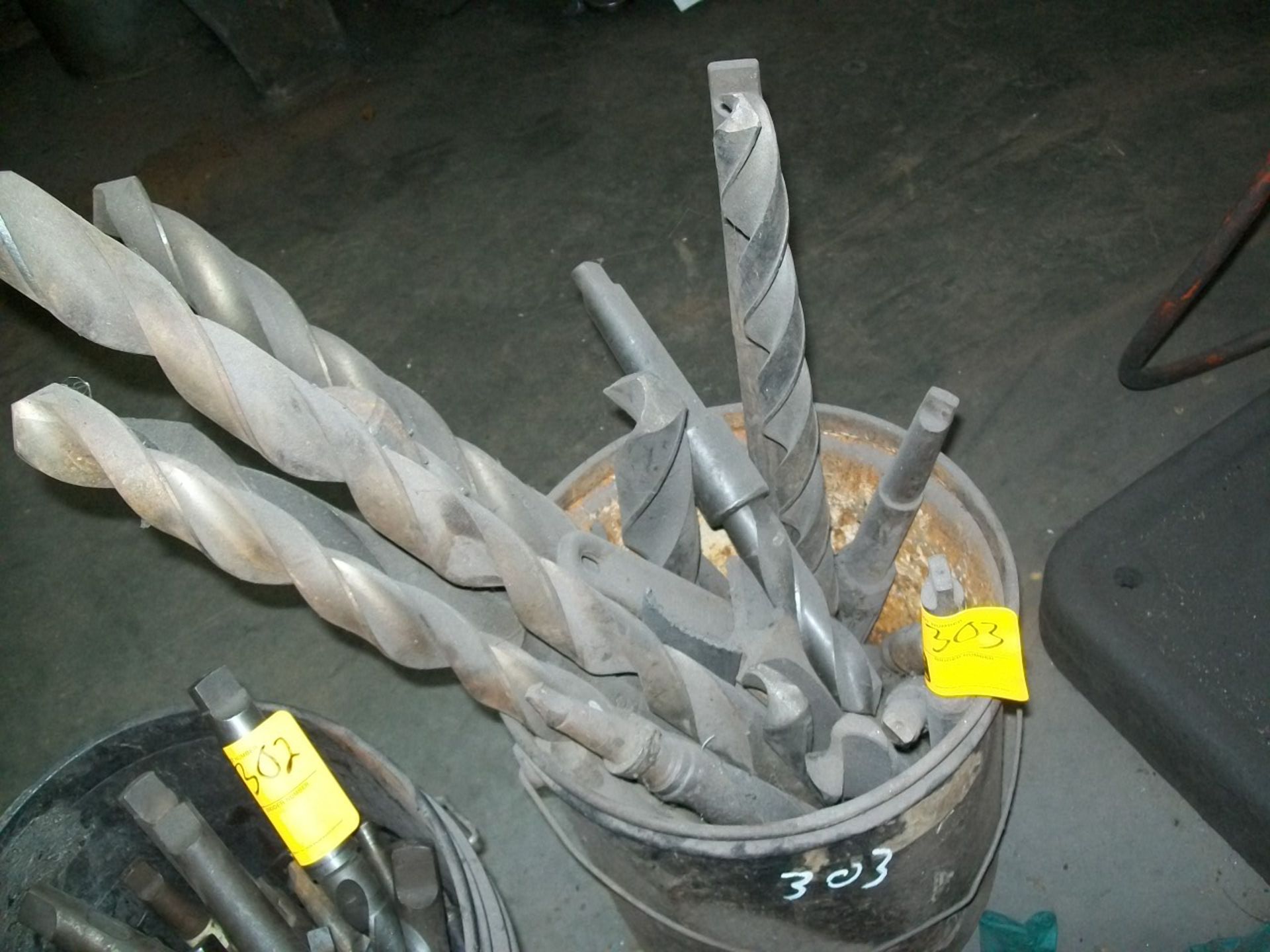 BUCKET OF LARGE DRILL BITS