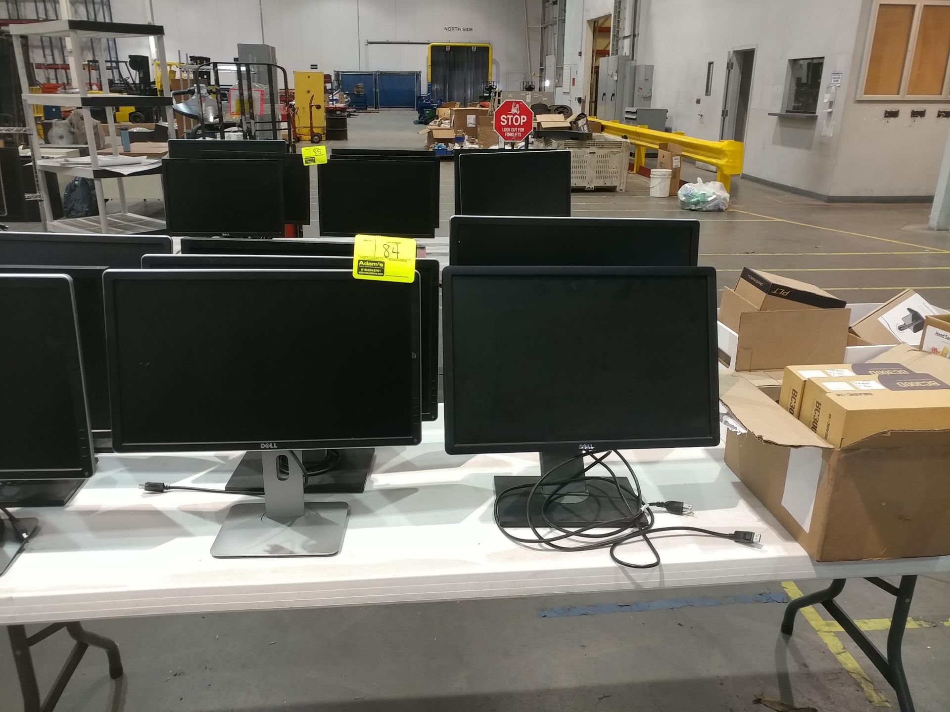 Table of monitors, HDMI cables, and portable two-way radio