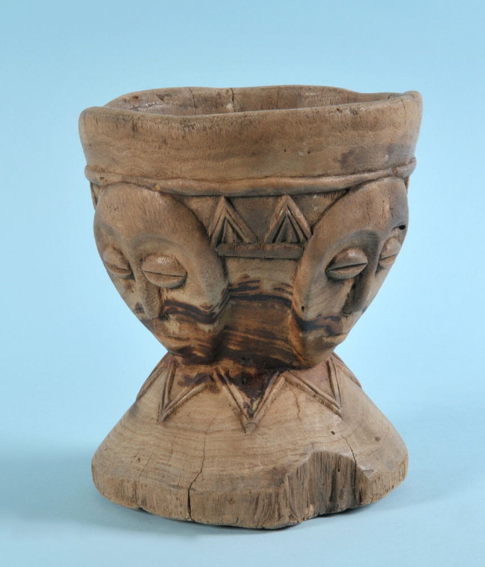 Afrikanische Schnitzerei - MörserHolz, braun gebeizt, geschnitztes Dekor mit 4 Masken, Rundfuß, H=