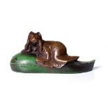 antique, Japanese netsuke, depicting a cat riding a tadpole. Early Showa