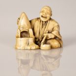 signed netsuke of man making "Okimono" Meiji Japan